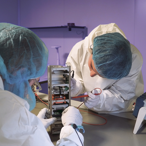 Students from the Polytechnic University of Turin or Politecnico di Torino perform test activities on the on the Spei Satelles papal satellite, as engineers with Tyvak International, a Terran Orbital subsidiary, supervise the students’ work. (Image Credit: Politecnico di Torino)