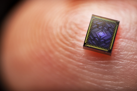 A photo shows one of Intel's Tunnel Falls chips on a human finger to display its scale. Silicon spin qubits are up to 1 million times smaller than other qubit types. The Tunnel Falls chip measures approximately 50-nanometers square, potentially allowing for faster scaling. (Credit: Intel Corporation)