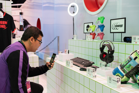 Benjamin Vo scans a QR code to watch a YouTube Short featuring tech products from Newegg inside the YouTube Drop Shop at VidCon Anaheim 2023 in Anaheim, Calif. (photo: Newegg)