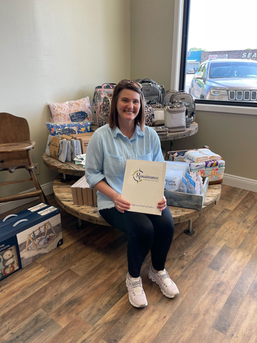 Angela Perrin, owner of Kudzu Cotton Boutique in Natchez, Mississippi, happily holds her Small Business Boost paperwork. (Photo: Business Wire)