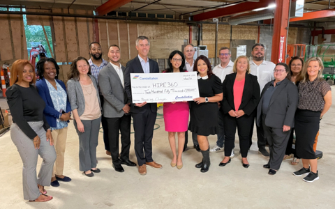 At the future site of a training and business development center on the South Side of Chicago, Constellation leaders present a $250,000 check to HIRE360 to support the nonprofit in its efforts to help women and minority workers gain access to good-paying union jobs in the building trades. (Photo: Business Wire)