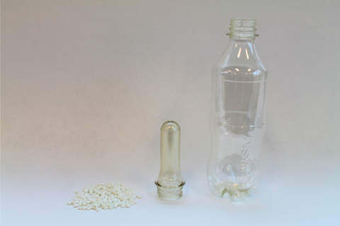 Advanced co-polyester made by Origin Materials and Husky Technologies using PET/F. Resin, mold, and bottle shown. (Photo: Business Wire)