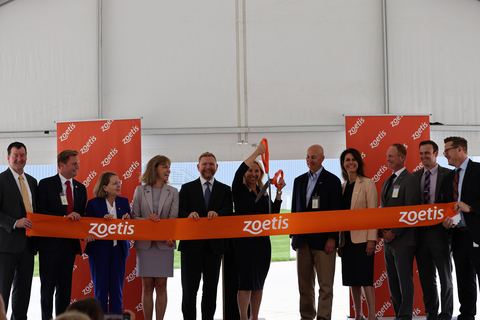 Zoetis CEO Kristin Peck (center), cuts the ribbon, marking the official opening of the company's new monoclonal antibodies (mAbs) expansion. Ms. Peck is pictured with Zoetis leadership and local officials. Source: Zoetis