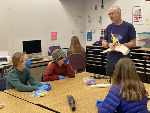 Colossal Scientific Advisory Board member, Dr. Matthew Wooller, in Alaskan classroom with adopted mammoth fossil “Burnt Ramen” (Photo: Business Wire)