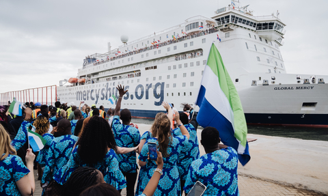 Sierra Leoneans welcome the Global Mercy. Docked in the Port of Freetown at the Queen Elizabeth II Quay, Mercy Ships' newest state-of-the-art ship will partner with the Ministry of Health of Sierra Leone to provide free specialized surgeries and targeted training for in-country healthcare professionals until June 2024. (Photo: Business Wire)