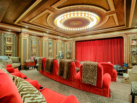 A posh home theater on the lower level was custom designed by theater specialist Theo Kalomirakis. It includes its own "concession stand," refrigerator, freezer, and sink. NewYorkLuxuryAuction.com.