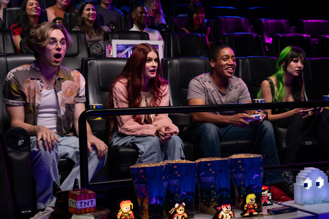 "The Gamer Lounge" contestants (from left) Skyler Seymour, Juliette Sureau, JR Ritcherson and Michelle Dao react to video game action on a movie theater screen. "The Gamer Lounge" is a reality-competition series on YouTube and part of Newegg's National Video Games Day celebration. (Photo: Newegg)