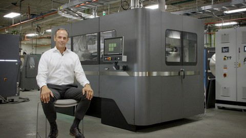 Paul Hauck, Chief Operating Officer for DSB Technologies, based in Janesville, Wisconsin, explains why the company has adopted the entire line of Desktop Metal X-Series metal binder jetting 3D printers for production of metal parts. Behind Hauck are the Desktop Metal X160Pro and, far left, the X25Pro. DSB is an experienced producer of metal parts with sinter-based technologies such as metal injection molding (MIM) and powder metallurgy (PM) — processing more than eight million pounds of powder into parts annually. (Photo: Business Wire)