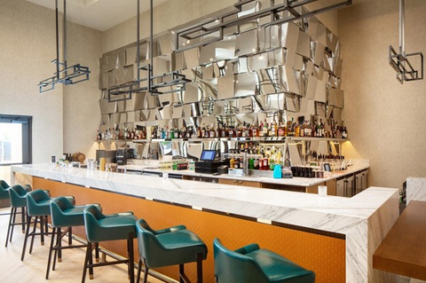 Unwind after a long day or meet colleagues for a celebratory drink at the bar. (Photo: Business Wire)