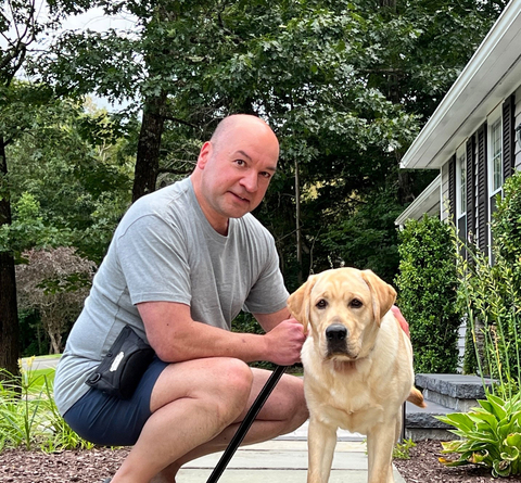 John Albanese, Voya Financial's VP, Corporate Security & Investigations with service dog Cooper. (Photo: Business Wire)