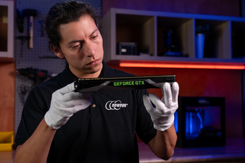 Joseph Olmedo of Newegg examines a graphics card to determine its condition. Newegg's new GPU Trade-In Program enables customers to trade in an eligible GPU and receive a trade-in value credit toward the purchase of a new qualifying graphics card. (Photo: Newegg)
