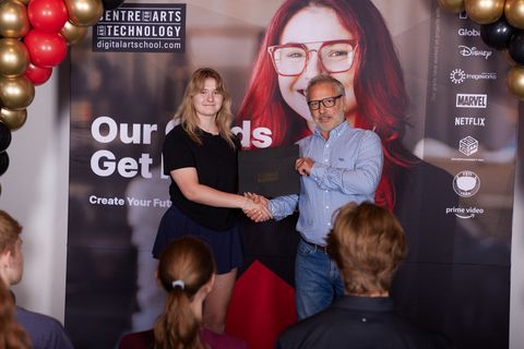 Professional Filmmaking Department Head Victor Poirier presents a full scholarship award to grand prize winner Sani Supinen. (Photo: Business Wire)