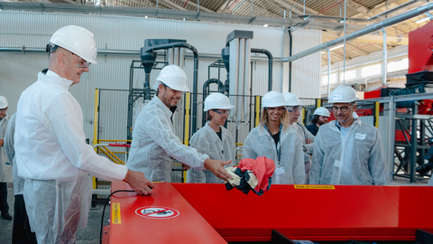 original Roland Lescure, French Minister of Industry (left) accompanied by Emmanuel Ladent, CEO Carbios (far right) and representatives of Carbios partner brands (On, Salomon and Puma), inaugurates the textile preparation line for biorecycling. (Photo: Carbios)
