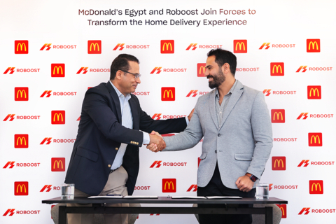 Essam Reda, Senior Director of People and Operations at McDonald's Egypt, and Mohamed Gessraha, CEO of Roboost, celebrate their partnership in Cairo to apply AI-powered solutions to home delivery operations. (Photo: AETOSWire)