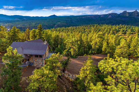 The property offers panoramic views of Colorado's iconic Chimney Rock National Monument (shown at upper right). There are four (4) structures on the 35-acre property: the main residence (shown at middle left), in addition to a guesthouse, cabin, and large workshop (not pictured). View details and floorplans at COLuxuryAuction.com. (Photo: Business Wire)