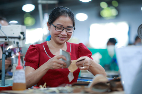 A factory worker in Vietnam wears VisionSpring eyeglasses as she works. (Photo: Business Wire)