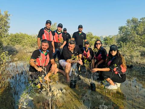 Members of the Terra Team working together to plant mangroves in Yas Island, Abu Dhabi (Photo: AETOSWire)
