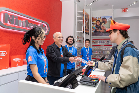 In this photo provided by Nintendo of America, Nintendo of America President Doug Bowser is selling the first Super Mario Bros. Wonder game at the Nintendo New York store during the midnight launch. (Photo: Business Wire)