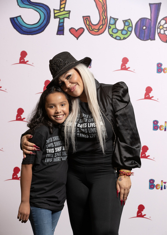 thumbnail La Dama Brava smiles with St. Jude patient Vanessa during the St. Jude Promesa y Esperanza® seminar. (Photo: Business Wire)