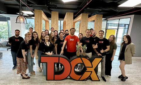 Daniel Mereuta, Country Director of TDCX Romania (first row, fifth from right) and employees settling into their new office space. (Photo: Business Wire)