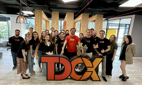 original Daniel Mereuta, Country Director of TDCX Romania (first row, fifth from right) and employees settling into their new office space. (Photo: Business Wire)