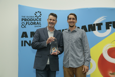 Eric Morgan, Braga Fresh vice president of environmental science and resources, and Charlie Dubbe, head of regenerative partnerships at Agrology, accept the Science & Technology Circle of Excellence Award at the IFPA Global Produce & Floral Show in Anaheim. (Photo: Business Wire)
