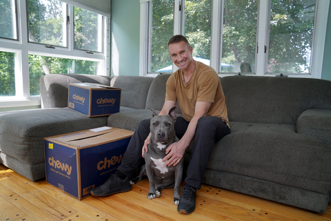 Dan and Blue with Chewy boxes. (Photo: Business Wire)