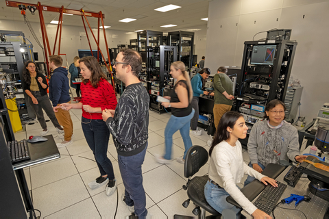 Photonic team members in the lab taking a unique silicon-based approach to delivering scalable, distributed, and fault-tolerant quantum computing and networking platform (Photo: Business Wire)