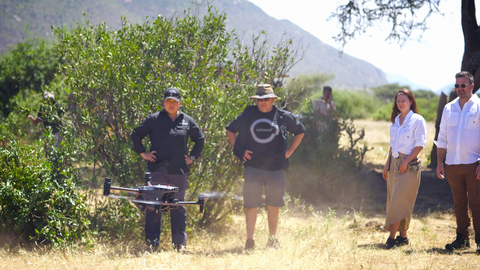 (L to R:) Wendy Kiso, Principal Scientist, Assisted Reproduction; Steve Metzler, Head of Animal Husbandry; Leah Brickson, Manager of AI and Machine Learning and Matt James, Chief Animal Officer pictured using a drone in Kenya. (Credit: Colossal Biosciences)