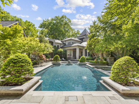 The pool is a centerpiece of the home’s outdoor living areas and is flanked by a covered cabana with a fireplace lounge (not pictured). The property’s 6 private and wooded acres provide plenty of room for outdoor entertaining on a grand scale. To be sure, the estate has hosted many celeb-attended charity galas, weddings and other events. NashvilleLuxuryAuction.com. (Photo: Business Wire)