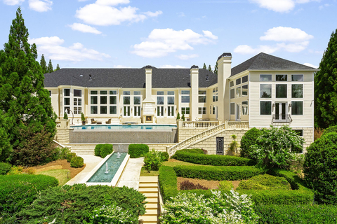 Designed in the style of the grand manors one might expect to find in the European countryside, the property includes a large pool deck with surrounding patio, fireplace and formal courtyard. Dual staircases lead to a reflecting pool with fountains, in addition to a decorative pond and fenced tennis court with stadium lighting (not pictured). GALuxuryAuction.com. (Photo: Business Wire)