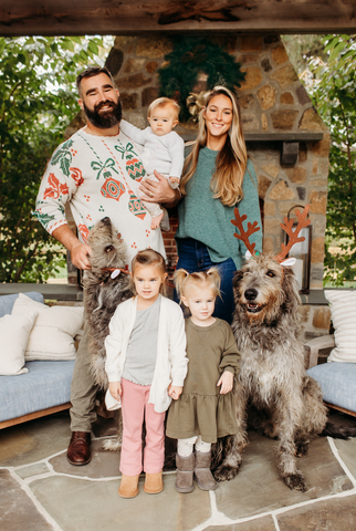 Jason, Kylie, Wyatt [4], Elliotte [2], and Bennett [8 months] Kelce scored a touchdown with an assist from dogs Winnie and Baloo during their 2023 holiday family photoshoot with design marketplace Minted. Photographer credit: Stephanie Beatty.