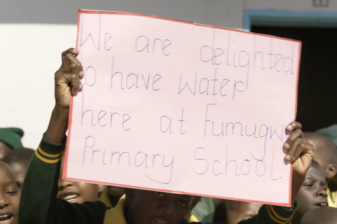 Students from Fumugwe Primary School in Zimbabwe welcome Kalahari Resorts & Conventions for the opening of an all new water system. Access to clean water not only gives children time to attend school, it also provides a safe learning environment. With access to latrines and education about good sanitation and hygiene practices, students have the resources they need to grow into healthy adults. (Photo: Business Wire)