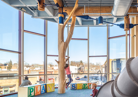 A view of the interior of the Children's Museum of Eau Claire with the city of Eau Claire in the background. [Photography courtesy of Kleine Leonard Photography.]