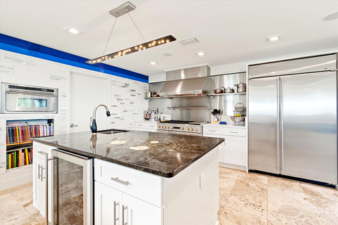 Fully remodeled in 2021, the chef’s kitchen includes top-notch appliances such as a gas range with grill and griddle, an oversized center island, bar seating for 6, and a walk-in pantry with dumbwaiter. OceanfrontLuxuryAuction.com. (Photo: Business Wire)