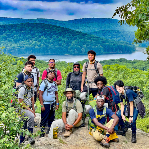 2023 Crawford Prize recipient Manny Almonte (bottom center) with Camping to Connect mentors and participants. Camping to Connect's goal is to change the narrative of who belongs in outdoor spaces and to help young men of color unlock their potential. Photo courtesy of Young Masterminds Initiative.