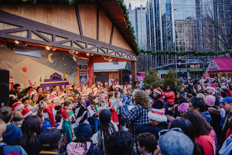 A choir sings during the Peoples Gas Holiday Market event in downtown Pittsburgh, Pa. during the 2023 holiday season. (Photo: Business Wire)
