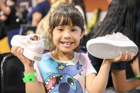 original A young girl receives news athletic shoes at her school through Soles4Souls' 4EveryKid program. (Photo: Business Wire)