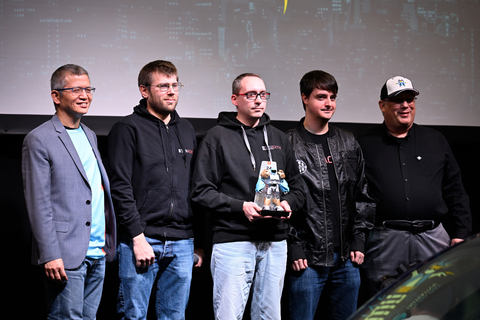 Pwn2Own Automotive 2024 winners: Max Cheng, VicOne’s CEO (left), and Dustin Childs, Head of Threat Awareness for the ZDI (right), awarding the title of Master of Pwn to the Synacktiv team (center). (Photo: Business Wire)