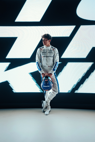 thumbnail Alex Albon, F1 driver for Williams Racing, wears the team's 2024 overalls and helmet featuring Komatsu's logo. (Photo: Business Wire)