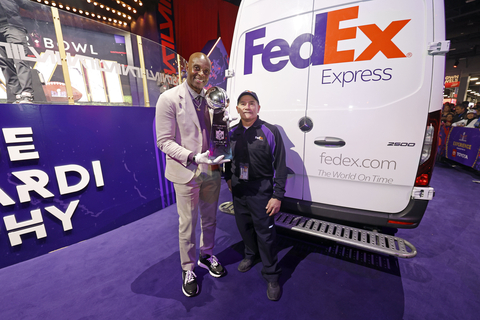 Jerry Rice and FedEx Express courier Bob Fini with the Vince Lombardi Trophy. Photos by Tyler Kaufman, Associated Press