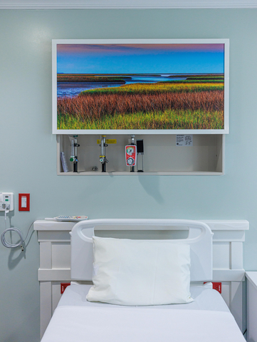 Art & Medical Equipment at the First Commerce Center for Compassionate Care. Strategically placed art in the patient rooms at the First Commerce Center for Compassionate Care help to conceal medical equipment. (Photo: Business Wire)