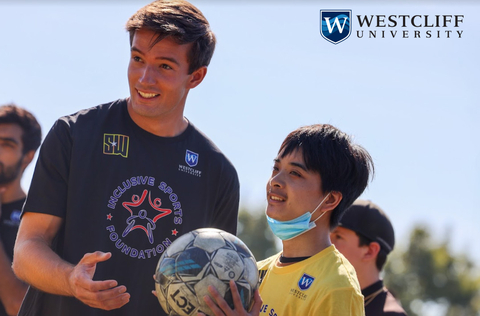 University Student Helping Children with Disabilities Participate in Sporting Activities During Westcliff's Inclusive Sports Days Event. (Photo: Business Wire)
