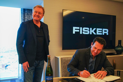 Fisker CEO Henrik Fisker and Mike Domenicone, Principal and owner of Classic Fisker, signing at NADA in Las Vegas. (Photo: Fisker Inc.)