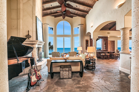 The grand salon features handsome columns, gentle archways, vaulted ceilings with exposed wood beams, and oversized windows allowing for ample natural light and inspiring ocean views. OceanfrontLuxuryAuction.com. (Photo: Business Wire)