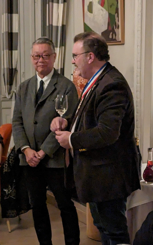 宮坂醸造社長の宮坂直孝氏(左)による日本酒の紹介。右はM.O.F.ソムリエのアルノー・シャンボス氏。（写真：ビジネスワイヤ）