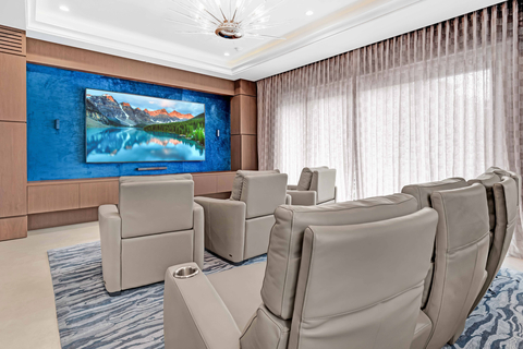 An elegant home theater includes plush cinema chairs – part of a $750,000 furnishings package included with the sale. All furniture is unused, as the property has not been occupied since its 2020 completion and has been kept in “brand new” condition, according to Platinum. CaymanLuxuryAuction.com. (Photo: Business Wire)