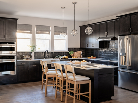 A model kitchen features the Organic Modern Bobby Berk x Tri Pointe Homes design style at the Context at Oakhurst community from Tri Pointe Homes. Photo Credit: Kara Mercer, Stylist Credit Teressa Johnson for Tri Pointe Homes
