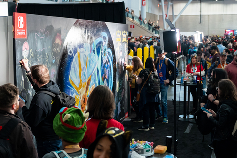 In this photo provided by Nintendo of America, fans gather to view a mural featuring a “Terastallizing” Eevee from the Pokémon Scarlet and Pokémon Violet games at PAX East.