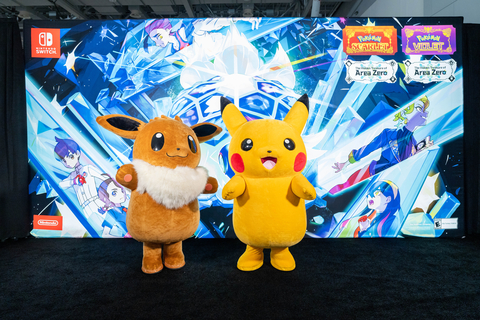 In this photo provided by Nintendo of America, Pikachu and Eevee stand in front of a banner at PAX East themed after The Hidden Treasure of Area Zero Part 2: The Indigo Disk DLC for Pokémon Scarlet or Pokémon Violet.